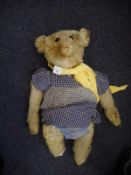 An early 20th century Stieff blonde plush Teddy bear:, with button to left ear,