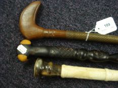 A carved bone and horn handled walking cane in the Chinese taste,