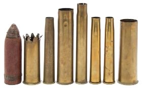 A WWI cast iron shell with fuse, together with a collection of seven various brass shell casings:,