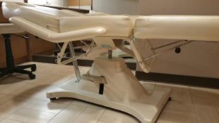 Cream Colored Leather Massage Table with adjustable feet and head positioning Rigging Cost: $55