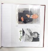 Album containing autographed photographs and postcards, some facsimile, predominantly politicians,