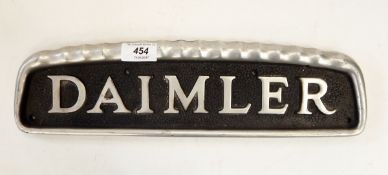 Daimler alloy radiator name plate, 39cm long and two other metal vehicle plates, one inscribed 