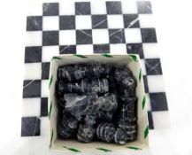 Modern marble chess board with carved variegated chessmen