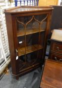 Mahogany-finish dwarf standing corner display cupboard enclosed by bi-glazed door, 63cm wide,