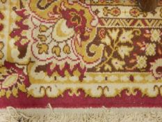 Eastern-style wool carpet, the red ground with central foliate scroll medallion,