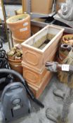 Three terracotta garden planters and a quantity of terracotta flowerpots