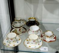 Pair of Minton coffee cups and saucers painted with sprigs of roses, pansies and forget-me-nots,