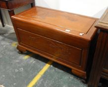 Oriental cedarwood coffer, the top carved bamboo tree, carved front panel and on ogee bracket feet,