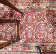 Eastern-style wool runner, the red ground allover with floral and boteh decoration,