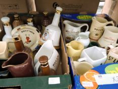 A large quantity of pub advertising jugs including Bell's Whisky, St.