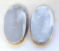 Pair of George V silver-backed gentleman's hairbrushes with engine-turned engraving,