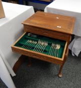 Canteen of cutlery, the handles decorated with roses, in a teak table canteen,