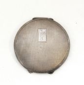 George VI lady's silver compact of circular form with engine-turned engraving, mirrored interior, 6.