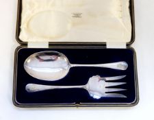 Pair of George V silver dessert servers with presentation inscription, line-engraved borders,