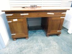 Mahogany pedestal writing desk with three frieze drawers, cupboard below, on pad feet,