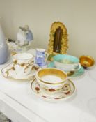 Porcelain frame of domed scallop form decorated in green with gilt scrolls,