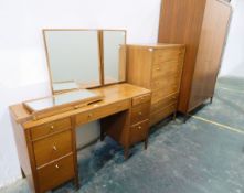 20th century teak bedroom suite by Maple viz:- a mirror-back dressing table with an arrangement of