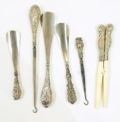 Pair of silver handled glove stretchers, silver handled button hook, three similar shoe-lifts,