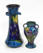 Quantity of Torquay pottery with blue ground and handpainted irises to comprise vases, plates, etc.