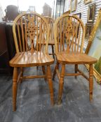 Set of three pine wheelback kitchen chairs with solid seats,