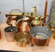 Large brass watering can, an embossed metal magazine rack, two large copper ewers,