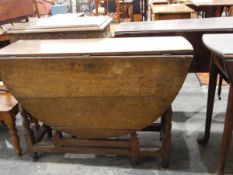 18th century oak gateleg table with drop-leaf oval top, on turned baluster supports, frieze drawer,