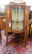 Edwardian mahogany bowfront corner display cupboard, the glazed door enclosing shelves,