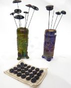 Green carnival glass hat pin stand of cylindrical form decorated with fruiting vines,