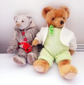 Grey bear wearing a knitted jumpsuit and a gold plush bear wearing a knitted jumpsuit with a cream
