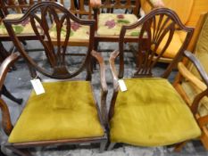 Two mahogany Hepplewhite-style shield-back open armchairs with pierced splats, upholstered seats,