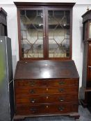 George III mahogany bureau/bookcase with dentil cornice over two astragal glazed doors,