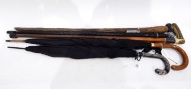 Two vintage umbrellas, a walking stick with a silver coloured metal collar, horn handle,
