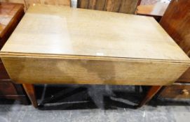 19th century oak drop-flap dining table with frieze drawer, on turned tapering legs with castors,