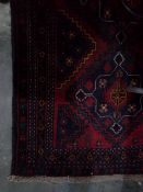 Handmade Eastern wool rug with dark blue ground, red zig-zag central field, geometric design,