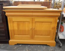 Modern pale chestnut side cupboard by Simon Knowles, with a pair of cushion frieze drawers,