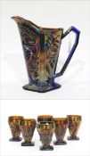 Blue carnival glass jug moulded with stylised flowers and six matching goblets (7)