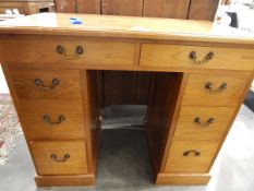 Lady's 20th century line inlaid walnut kneehole desk having an arrangement of eight drawers,