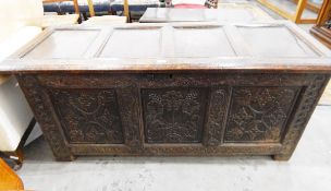 Early 18th century three-panelled carved oak coffer with a four-panelled cover and on stile feet,