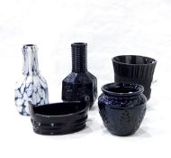 Two Sowerby pressed glass vases of bottle form with panelled sides decorated with flowers,