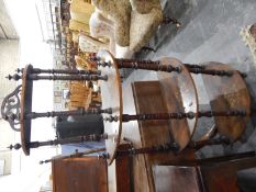 Late Victorian bowfront whatnot of four tiers, with painted decoration,