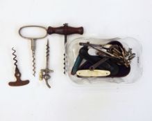 Corkscrew with turned mahogany handle and steel screw, a metal corkscrew with vent mechanism,