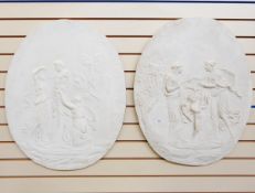 Pair of plaster wall medallions of oval form,