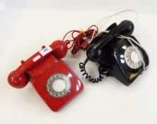 Vintage red plastic telephone and another black example,