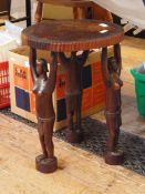 Carved hardwood stool, probably African, the circular seat decorated with a scene of hunters,
