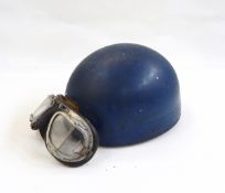 Vintage motorcycle helmet with the logo of a flying eagle and a pair of vintage motorcycle goggles