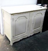 White painted dwarf two-door cupboard enclosed by panelled doors,
