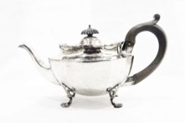 Edwardian silver teapot by Nathan & Hayes, Chester 1901 of panelled oval form on four scroll feet,