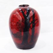 Royal Doulton flambé vase with typical red ground, silhouette of bear, trees, mistletoe and birds,