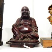 Early 20th century large carved hardwood figure of a seated laughing Buddha with bone teeth,