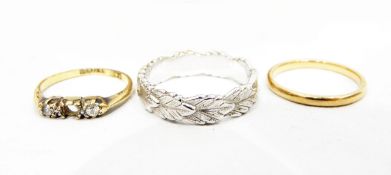 18ct gold and three-stone diamond ring (centre stone missing), an 18ct gold wedding ring,
